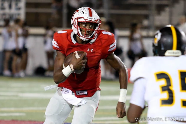 Tyler Lee quarterback Chance Amie, looks for running room.