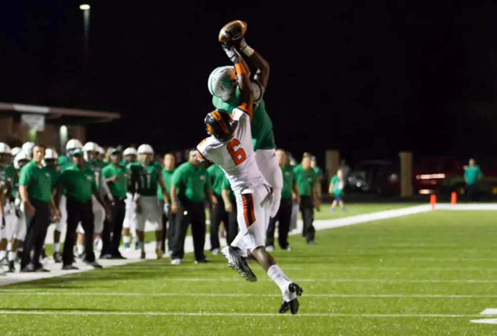 Tatum's Martin Williams goes up for a catch against the defense of Gilmer's Quinn Fluellen during their game Friday night in Tatum. (Mark Martin, ETSN.fm)
